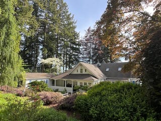 Before: a mossy asphalt shingle roof on the home, Bremerton, Washington, ahead of a Copper Penny Interlock Shake aluminum roof