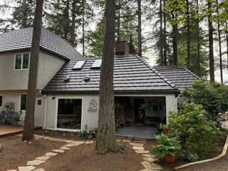 Colonial Brown Interlock Shake aluminum roof on a colonial-style home with a metal roof being installed in, Bellingham, Washington