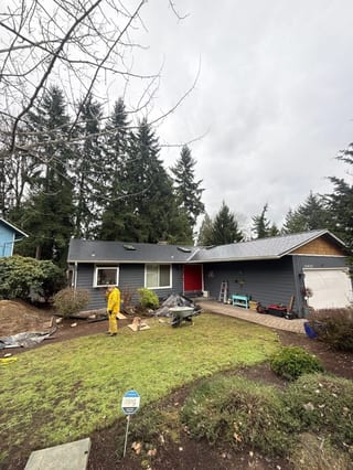 Black Interlock Slate aluminum roof on a grey home with a grey roof in a suburban setting, Redmond, Washington