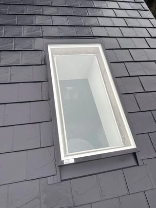 Black Interlock Slate aluminum roof on a house with a slate metal roof in a forested suburban area, Redmond, Washington