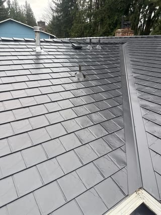 Black Interlock Slate aluminum roof on a grey single-family home with Interlock Slate aluminum, Redmond, Washington