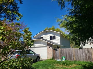 Deep Charcoal Interlock Slate aluminum roof on a white ranch home with a metal roof on a suburban street, Lynnwood, Washington