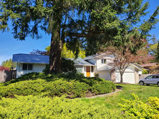 Deep Charcoal Interlock Slate aluminum roof on a white ranch-style home with a metal roof in a suburban, Lynnwood, Washington