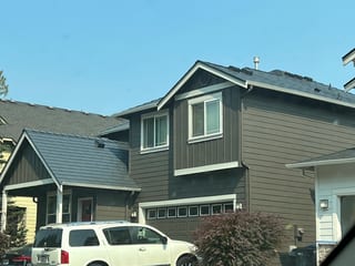 Deep Charcoal Interlock Slate aluminum roof on a two-storey home with dormers and a metal roof in, Lynnwood, Washington