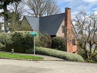 Deep Charcoal Interlock Slate aluminum roof on a two-storey colonial home with dormers in a suburban, Seattle, Washington