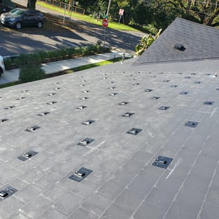 Black Interlock Slate aluminum roof on a modern home with a black metal roof in an urban setting, Ridgefield, Washington
