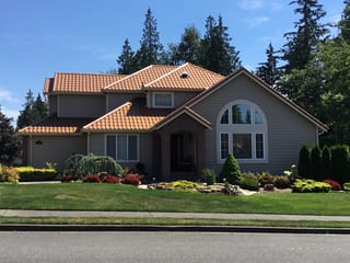 Aged Copper Interlock Tile aluminum roof on a two-storey home with dormers and an Interlock Tile roof, Arlington, Washington