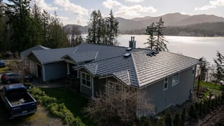 Deep Charcoal Interlock Shake aluminum roof on a grey ranch home on a waterfront property with a metal roof, Bellingham, Washington