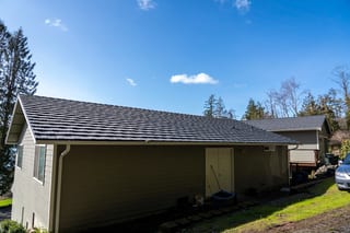 Deep Charcoal Interlock Shake aluminum roof on a brown ranch-style home with a metal roof in a rural area, Bellingham, Washington