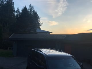 Before: the old roof on the home, Belfair, Washington, ahead of a Musket Grey Interlock Standing Seam aluminum roof