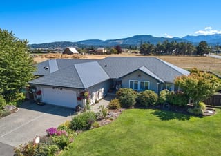 Deep Charcoal Interlock Slate aluminum roof on a two-storey home with a metal roof in a rural mountain, Sequim, Washington
