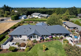 Deep Charcoal Interlock Slate aluminum roof on a grey ranch-style home in a rural setting with a metal roof, Sequim, Washington
