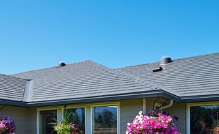 Deep Charcoal Interlock Slate aluminum roof on a tan single-storey home with a metal roof in a suburban, Sequim, Washington