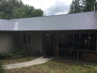 Deep Charcoal Interlock Cedar Shingle aluminum roof on a home with a brown exterior and a metal roof under, Tenino, Washington