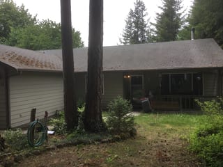 Before: a worn out asphalt shingle roof on the home, Tenino, Washington, ahead of a Deep Charcoal Interlock Cedar Shingle aluminum roof