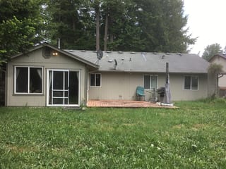 Before: a worn out asphalt shingle roof on the home, Tenino, Washington, ahead of a Deep Charcoal Interlock Cedar Shingle aluminum roof