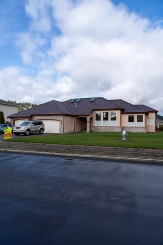 Colonial Brown Interlock Shake aluminum roof on a colonial home with a brown roof in a forested suburban, Orting, Washington