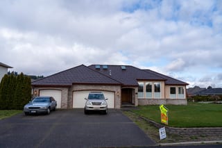 Colonial Brown Interlock Shake aluminum roof on a colonial style home with a metal roof in a rural setting, Orting, Washington
