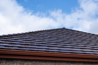 Colonial Brown Interlock Shake aluminum roof on a brown colonial home with a colonial brown metal roof in a, Orting, Washington