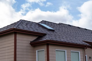 Colonial Brown Interlock Shake aluminum roof on a tan home with Colonial roof among tall pines, Orting, Washington