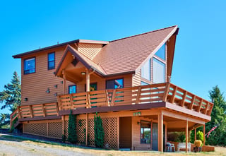 Copper Penny Interlock Cedar Shingle aluminum roof on a two-storey chalet with a copper penny metal roof in the, Sequim, Washington