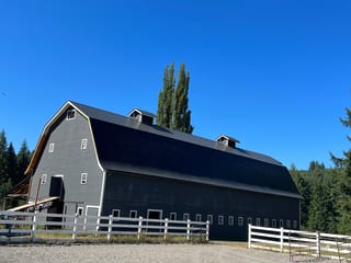 Black Interlock Slate aluminum roof on a black two-storey home with dormers in a forested rural, Longview, Washington