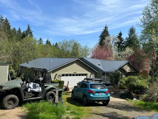 Deep Charcoal Interlock Cedar Shingle aluminum roof on a house with a metal roof in a forested rural area, Longview, Washington