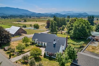 Black Interlock Slate aluminum roof on a white home with a black metal roof in a rural setting, Enumclaw, Washington