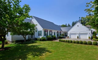 Black Interlock Slate aluminum roof on a white single-family home with a metal roof among tall, Enumclaw, Washington