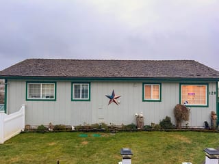 Before: a wind damaged wood shake roof on the home, Hoquiam, Washington, ahead of a Copper Penny Interlock Cedar Shingle aluminum roof