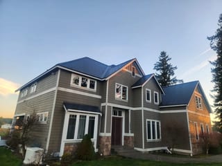 Deep Charcoal Interlock Slate aluminum roof on a two-storey home with a metal roof in a rural setting, Buckley, Washington
