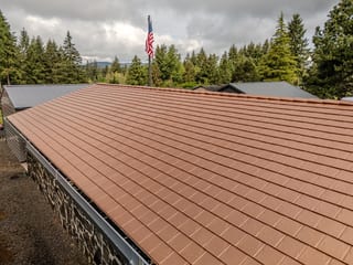 Copper Penny Interlock Slate aluminum roof on a brown home with a copper penny metal roof in a forested, Castle Rock, Washington