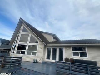 Before: the old roof on a modern single-family home with a black metal roof in, Ocean Shores, Washington, ahead of a Black Interlock Slate aluminum roof