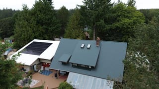 Hunter Green Interlock Cedar Shingle aluminum roof on a two-storey home with hunter green metal roof and chimney, University Place, Washington