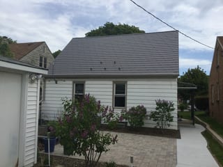 Weathered Interlock Slate aluminum roof on a white Cape Cod style home with a grey metal roof, Milwaukee, Wisconsin
