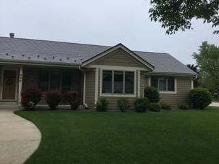Colonial Brown Interlock Slate aluminum roof on a colonial brown ranch home with a grey roof in a forested, Port Washington, Wisconsin
