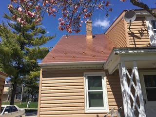 Aged Copper Interlock Slate aluminum roof on a tan single-family home with a copper metal roof and white, Watertown, Wisconsin
