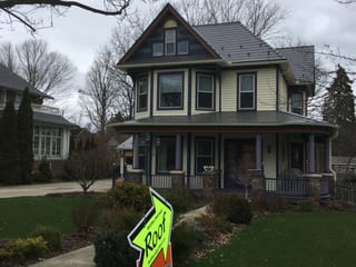 Weathered Interlock Slate aluminum roof on a two-storey Victorian home with dormers in a forested, Mayville, Wisconsin