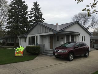 Deep Charcoal Interlock Slate aluminum roof on a white single-family home with a metal roof in a rural, Milwaukee, Wisconsin
