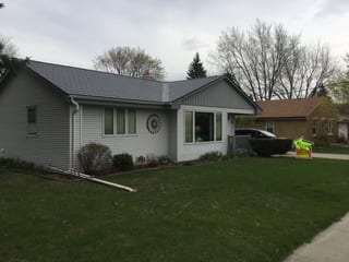 Deep Charcoal Interlock Slate aluminum roof on a Deep Charcoal Interlock Slate metal roof on a white ranch, Milwaukee, Wisconsin