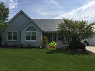 Tudor Brown Interlock Slate aluminum roof on a grey Colonial home with a metal roof on a rural property, Burlington, Wisconsin