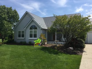 Tudor Brown Interlock Slate aluminum roof on a Tudor home with a metal roof in a rural green setting, Burlington, Wisconsin