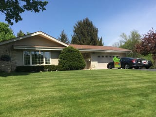 Aged Copper Interlock Slate aluminum roof on a single-storey home with a gable roof in a forested, Colgate, Wisconsin