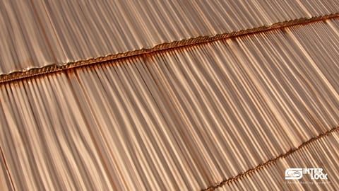 Close-up of Interlock® solid copper shake panels — hand-split shake relief in mill-finish copper