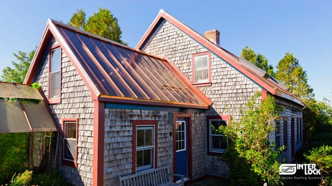 Close-up of Interlock® copper standing seam panels — vertical-rib profile in mill-finish copper
