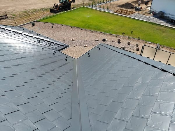 Deep Charcoal Interlock Slate aluminum roof on a Dunmore home with a metal roof in a rural setting, Dunmore, Alberta