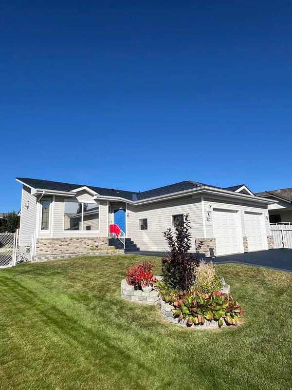 Deep Charcoal Interlock Cedar Shingle aluminum roof on a white ranch home with a deep charcoal metal roof in a, Stony Plain, Alberta