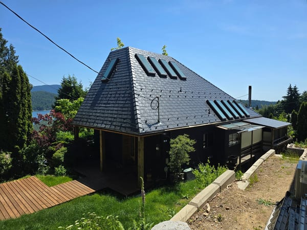 Deep Charcoal Interlock Slate aluminum roof on a Deep Charcoal metal roof on a home overlooking the ocean, Gibsons, British Columbia
