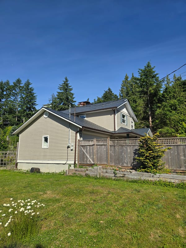 Deep Charcoal Interlock Slate aluminum roof on a two-storey home with Interlock Slate metal roof in Deep, Gibsons, British Columbia