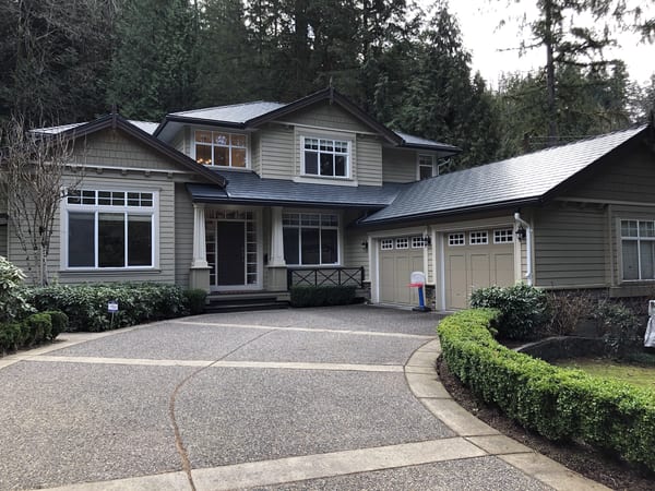Two-story Craftsman home in North Vancouver with Interlock deep charcoal aluminum slate metal roofing featuring a multi-plane complex roof and covered front entry.